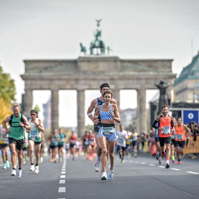Leah Fitzgerald at the Berlin Marathon's finish Line in front of the Brandenburg Gate
