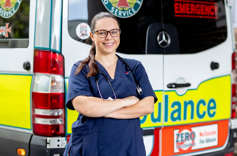 Nurse in front of ambulance