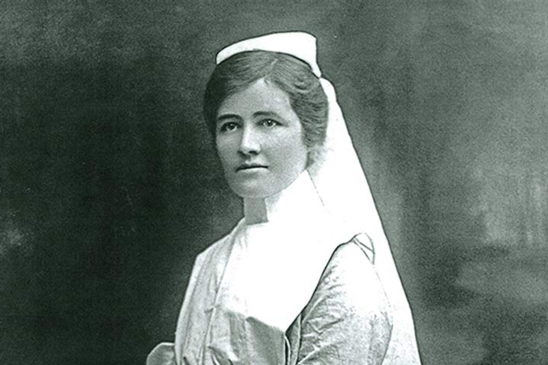 Historical black and white photo of woman in nursing uniform