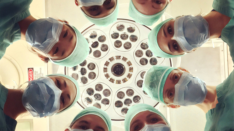 A circle of surgeons looking down from above