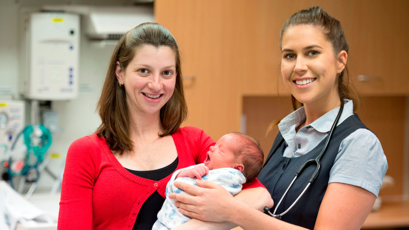 Young nurse with new mother and baby