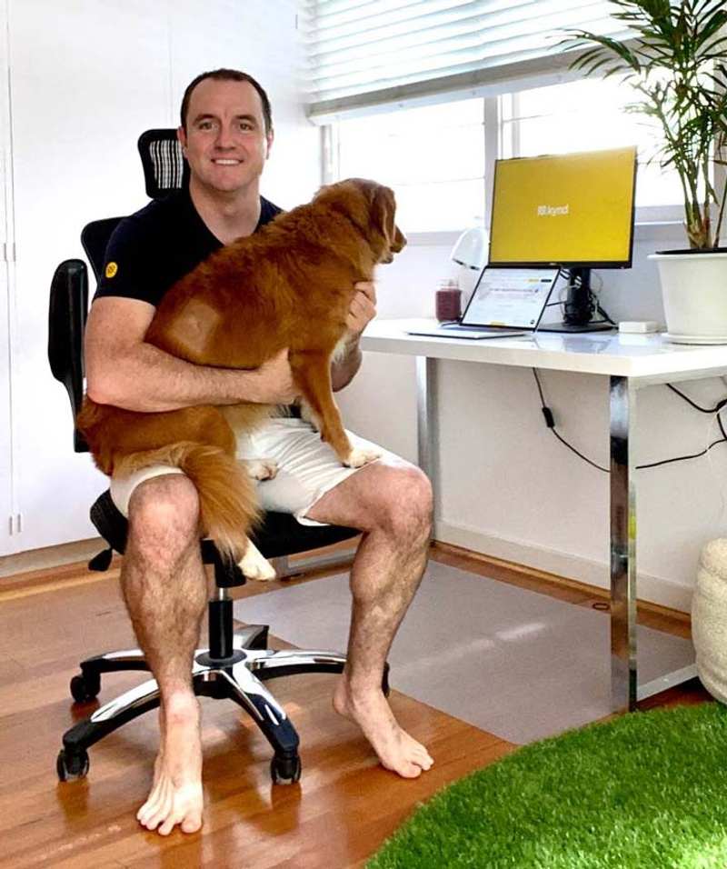 Man sitting on chair holding a dog