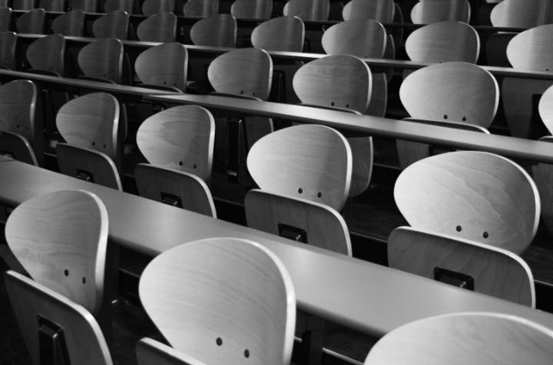 Rows of desks and chairs in a classroom