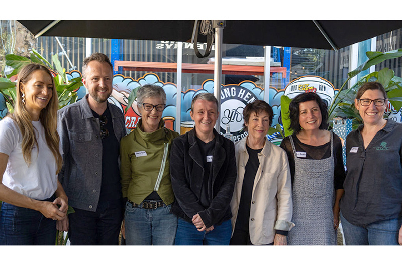 A group of seven people smiling at the camera