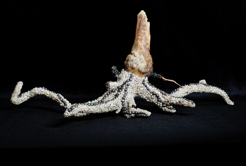 Artwork of an octopus made of driftwood and pearls