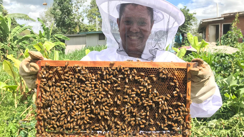 Villager with hive frame - credit Cooper Schouten