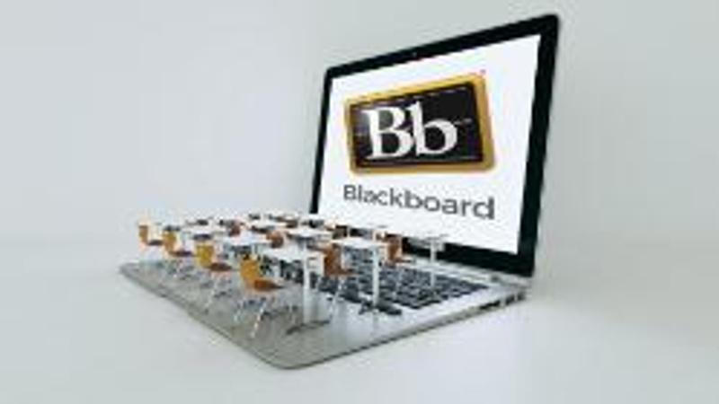 classroom desks on a laptop with Blackboard lgo on the screen