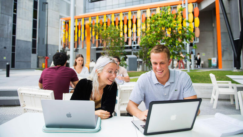 Students seated with laptops at Gold Coast campus