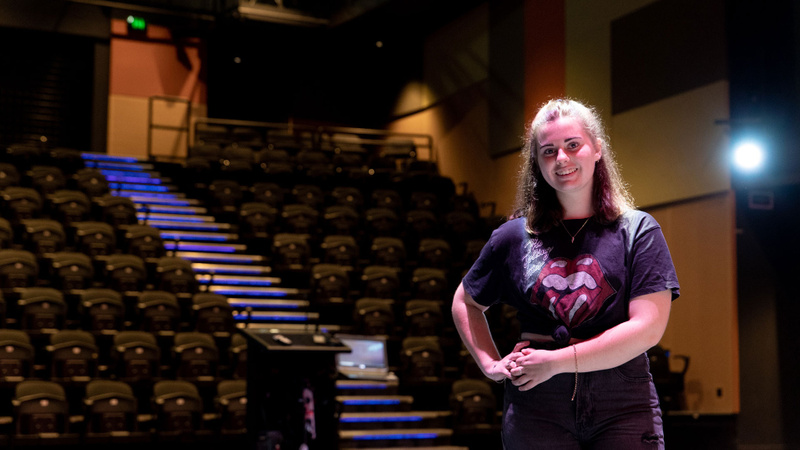 Female student smiling while standing in auditorium at Coomera campus