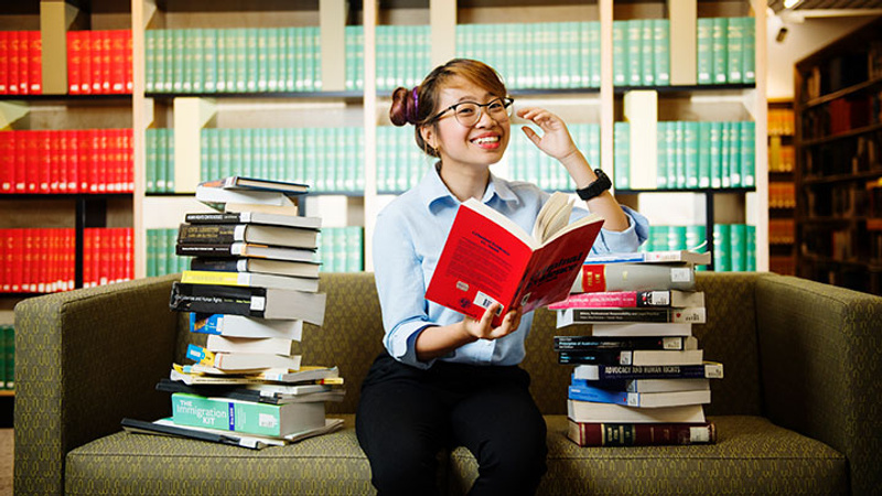 International law student reading books in library